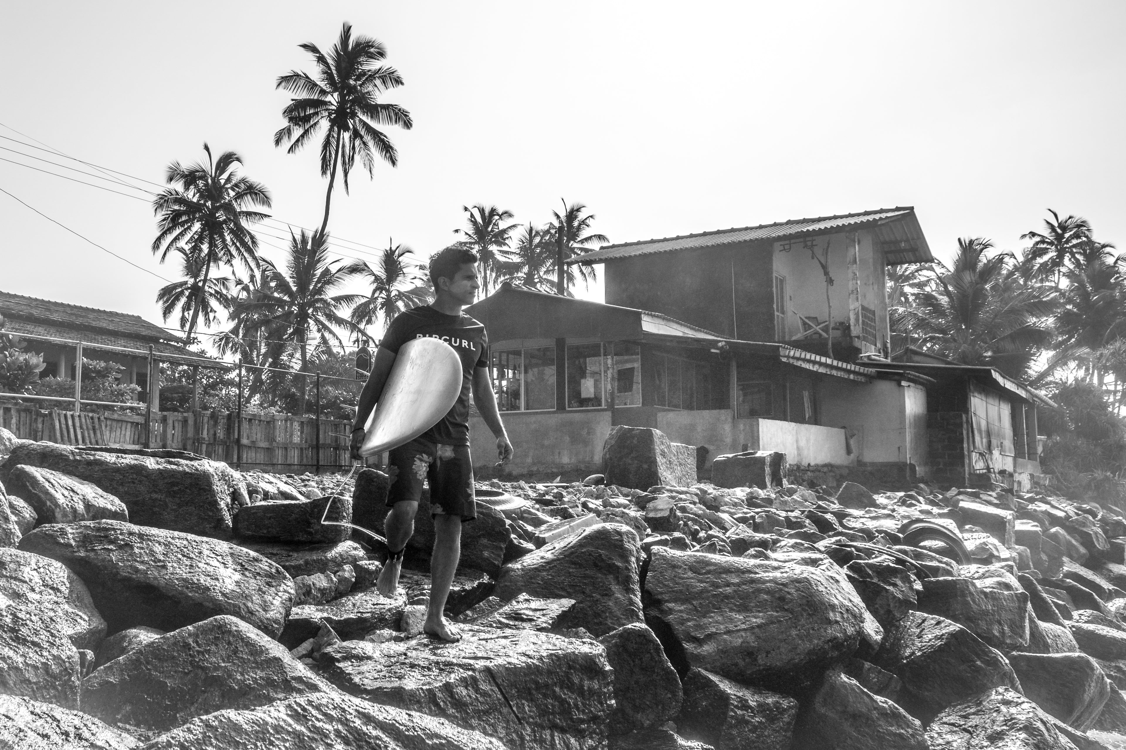 Photo of a surfer about to paddle out in Ahangama Sri Lanka